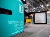 A blue cardboard box sits in the foreground. It reads, 'temperature sensitive product, thermosafe.com/Orion'. A worker and…