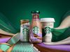 Three Starbucks packaging designs. In the middle, a plastic Frappuccino bottle with pink, purple and brown accents; to its…
