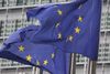Two EU flags on flagpoles flying in the breeze