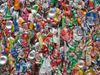 Lots of crushed cans gathered into a bale