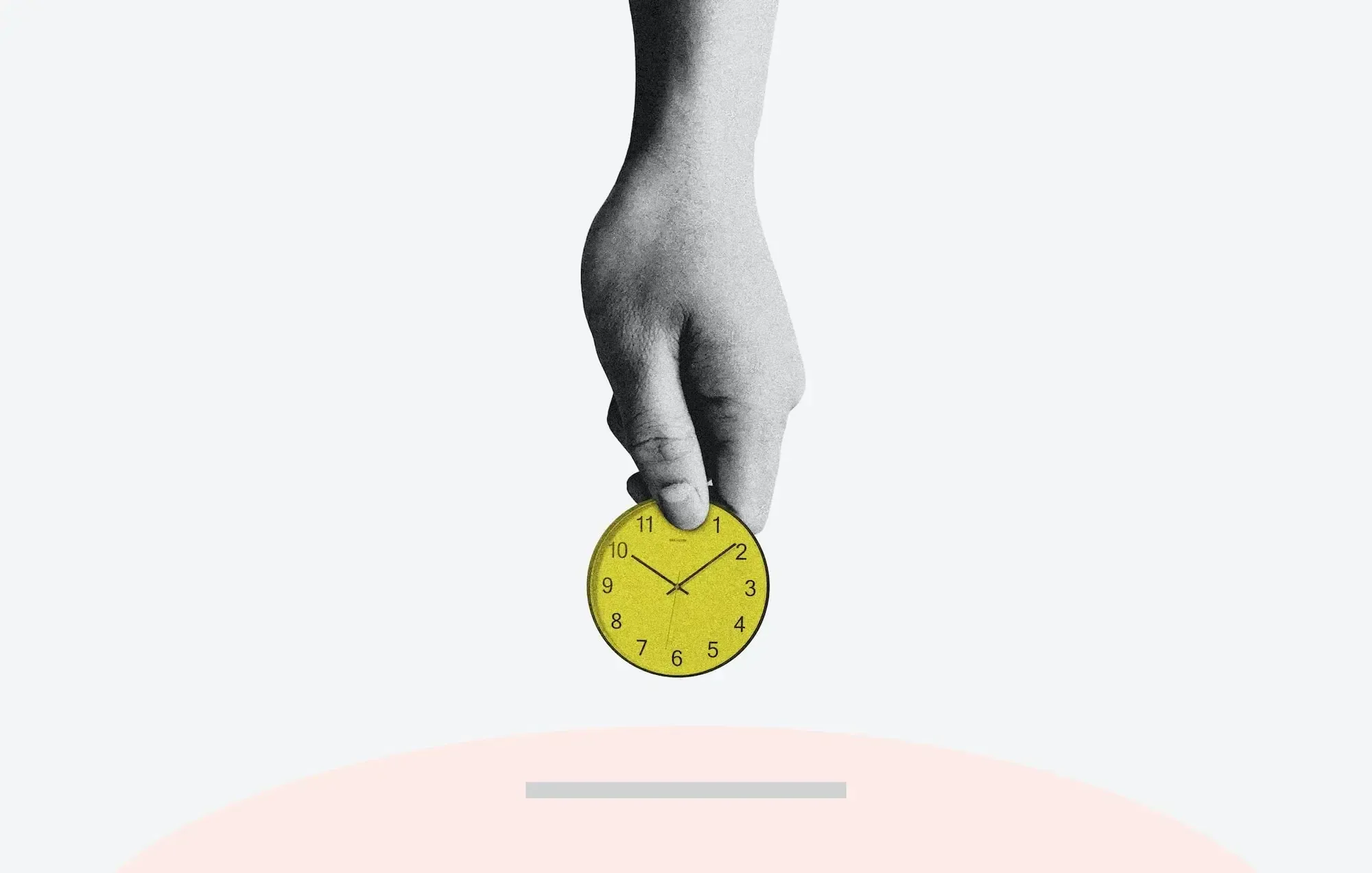 Hand holding a tiny yellow clock and putting it in a slit. 