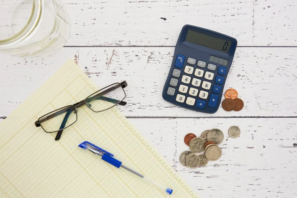 Coins and a calculator — pricing up a UK property logbook