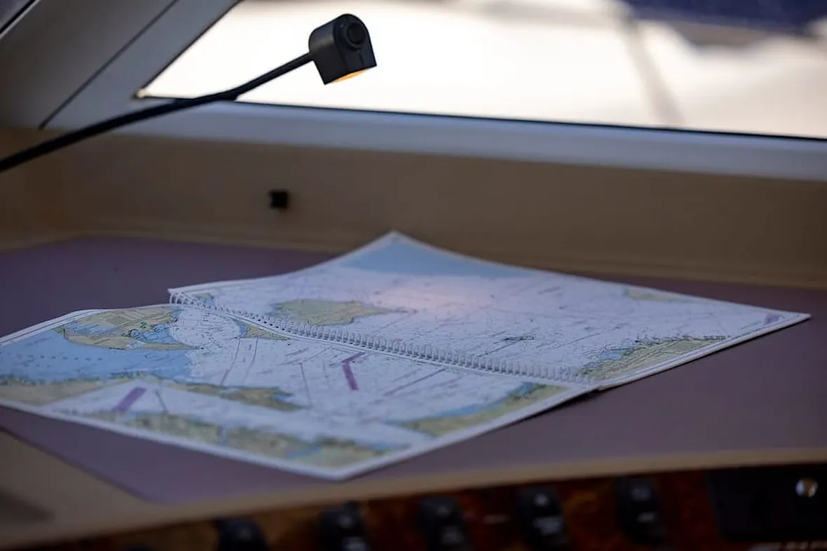 Yacht navigator plotting a course, RYA personal logbooks record sea miles and qualifying passages.