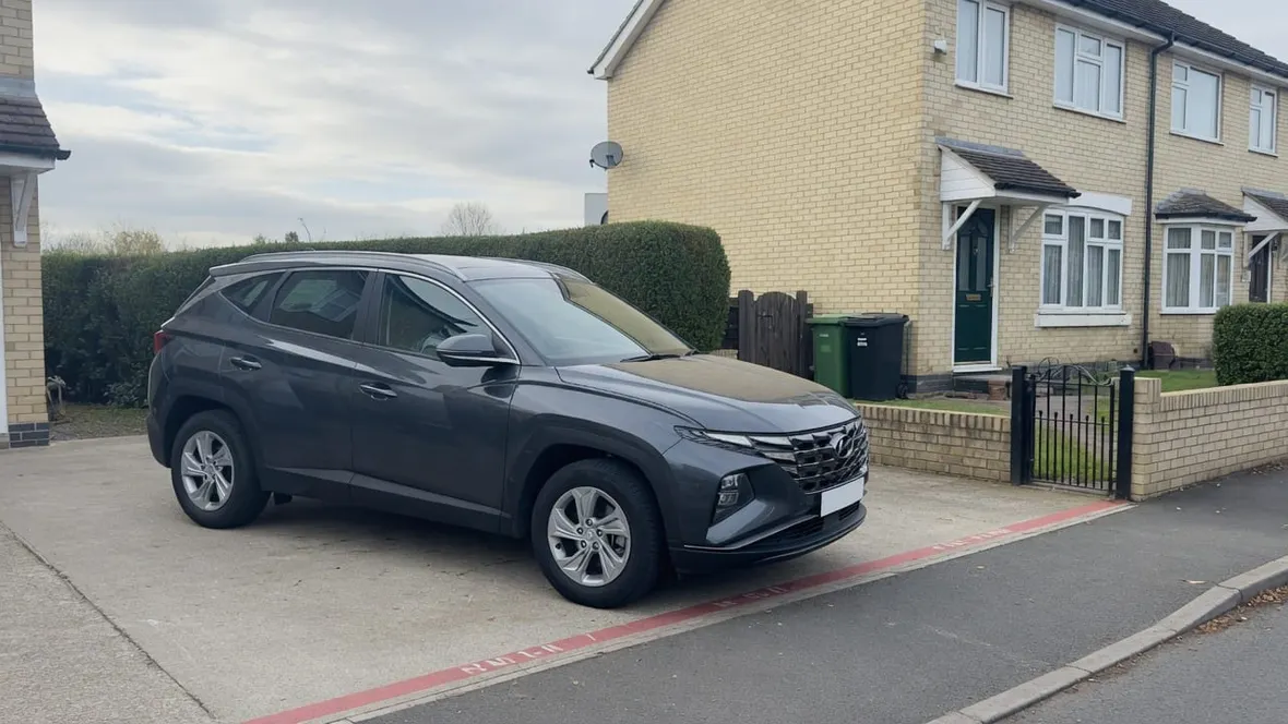 A grey Hyundai SUV parked on the driveway of a UK home