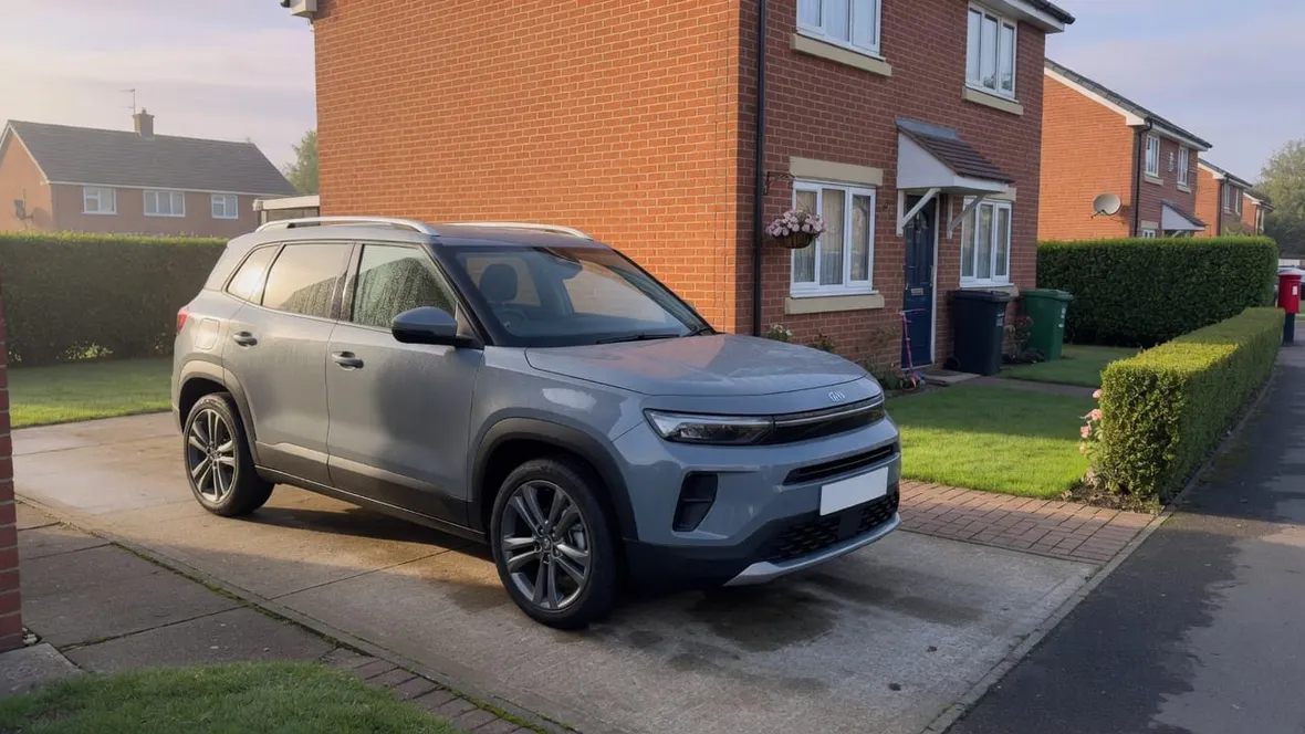 A grey Nissan style crossover parked on a suburban UK driveway