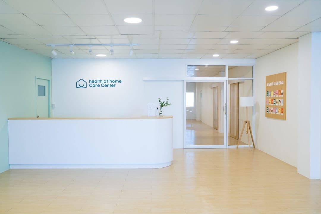 A UK care home staff member supporting a resident — CQC inspection records are the compliance foundation for 50,000 UK care providers.