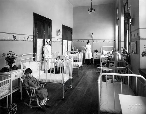 A UK nurse on ward — NMC revalidation requires 450 practice hours and 35 hours of CPD every three years.