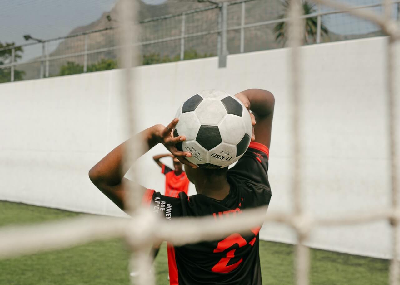 man about to throw soccer ball onto the field