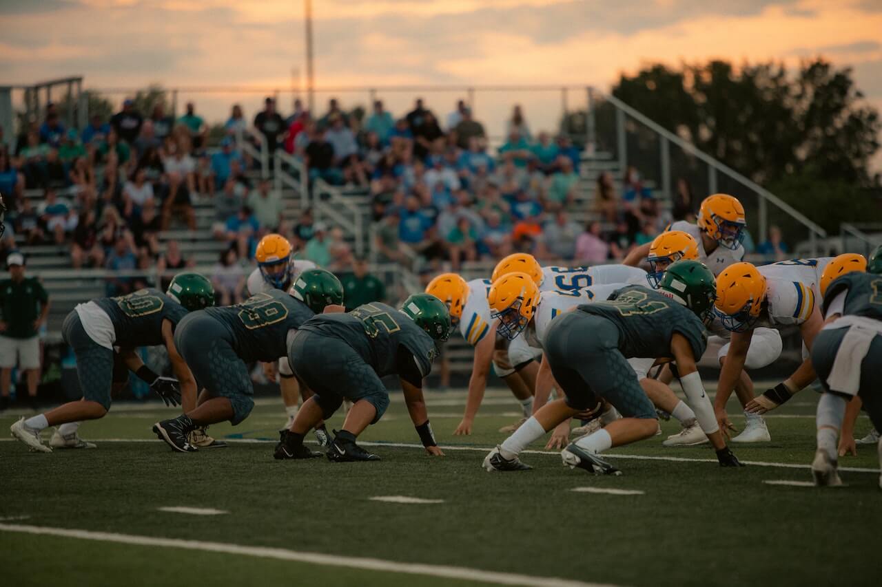 football players in position for a new round