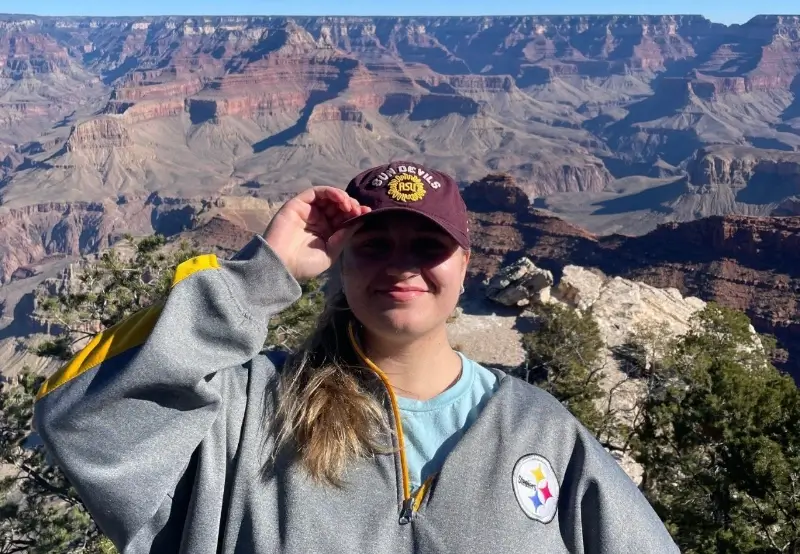 Arizona State University student in front of natural rock formations