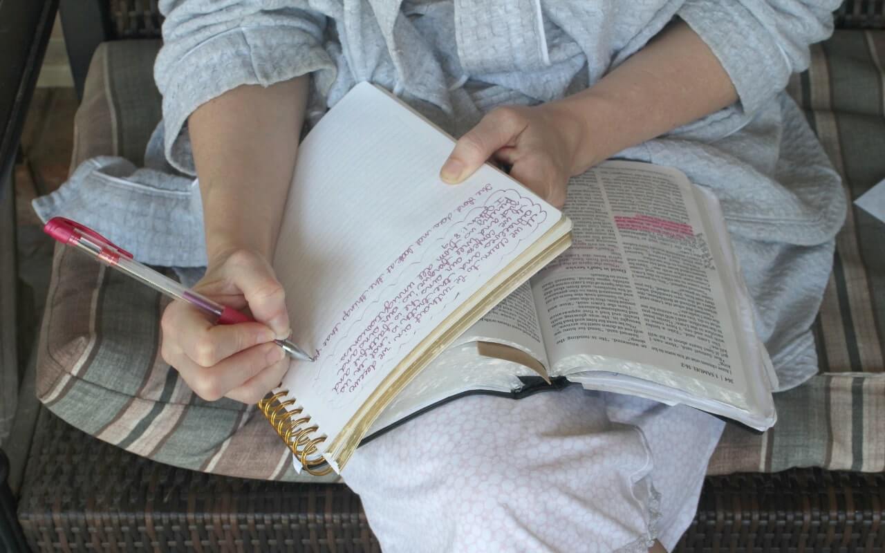 theology student takes notes from assigned text