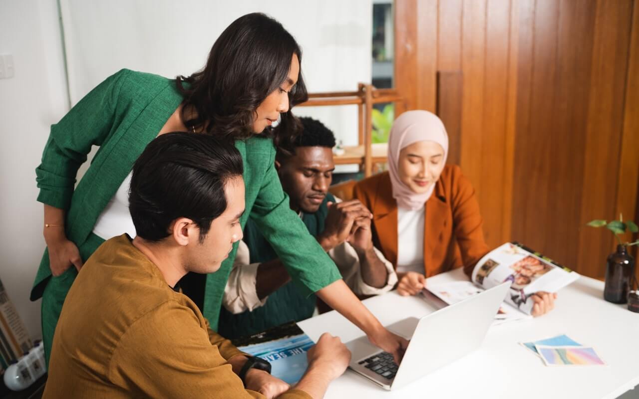 four master's degree students compare notes