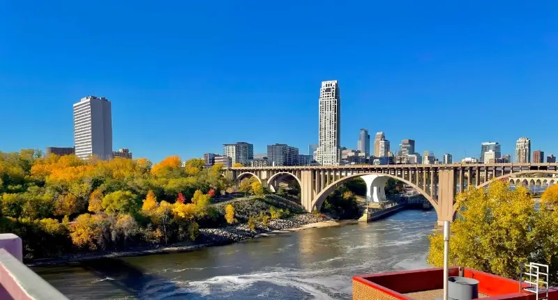 blue skies over a bridge on a college campus