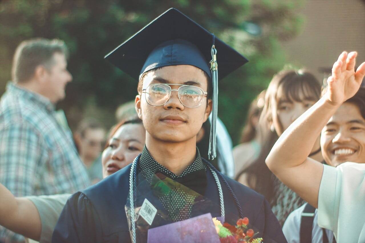 male student at graduation with family members