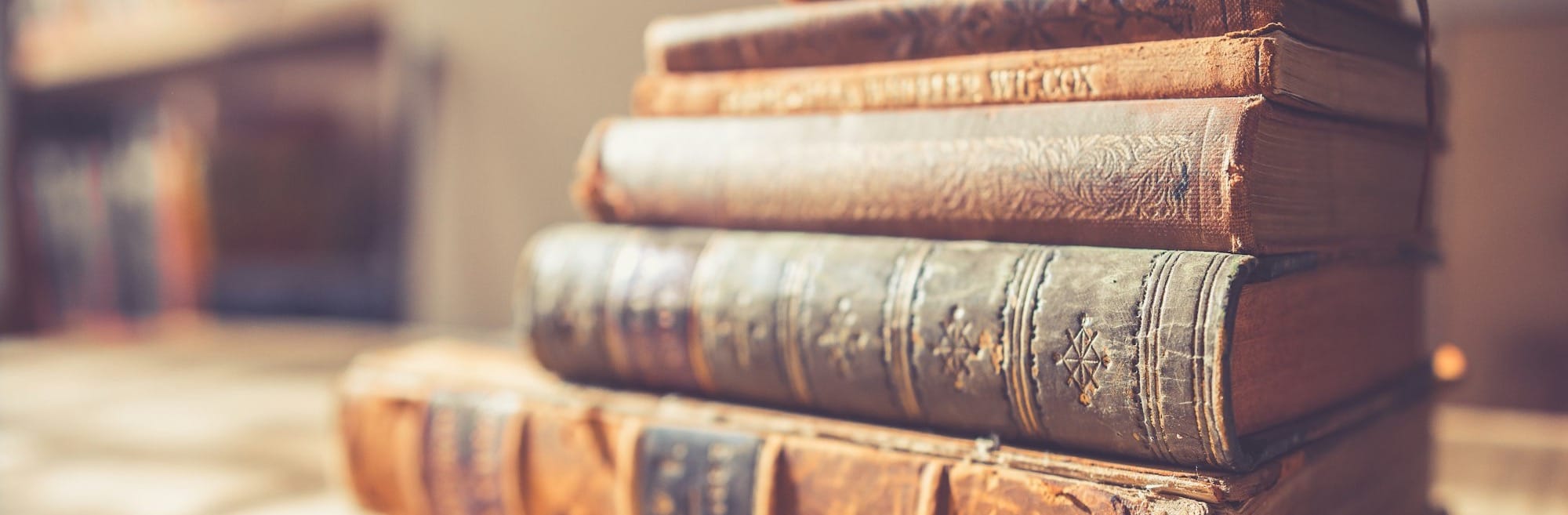 stack of six brown hardbound books