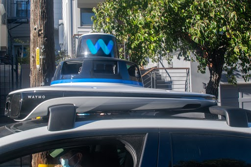 Close-up of a Waymo vehicle's lit rooftop sensor dome, used to help riders identify their car.