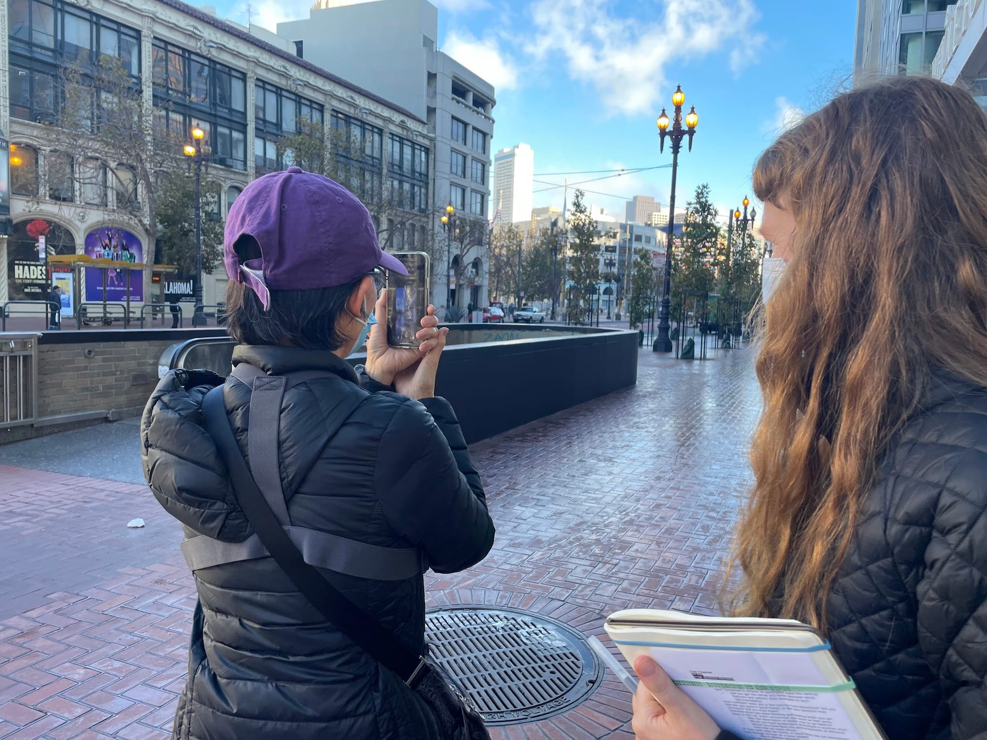 A participant and a researcher standing on a plaza sidewalk during an orientation exercise.