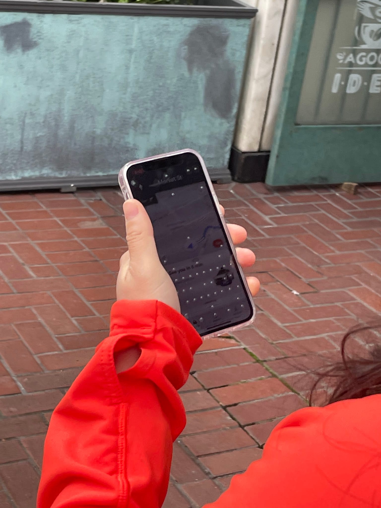 A participant holding a phone running the Waymo app prototype.