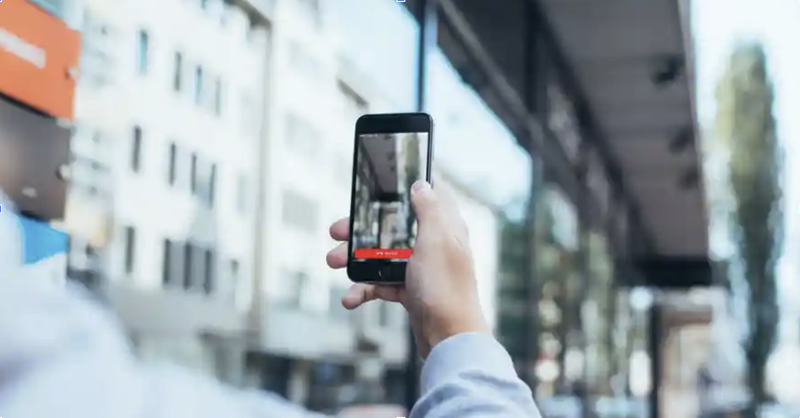 A participant holding up a phone to show their surroundings during a Rider Support video chat test.