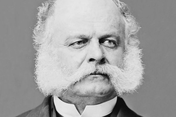 An old, melancholy general with fluffy while facial hair nearly everywhere but his chin.