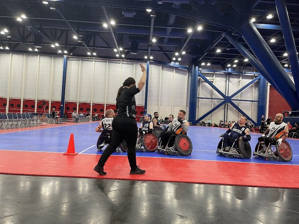 A person in wheelchairs on a blue and red court

Description automatically generated