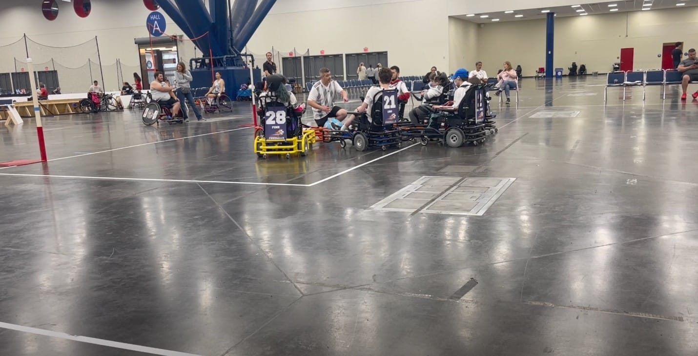 A group of people in wheelchairs

Description automatically generated