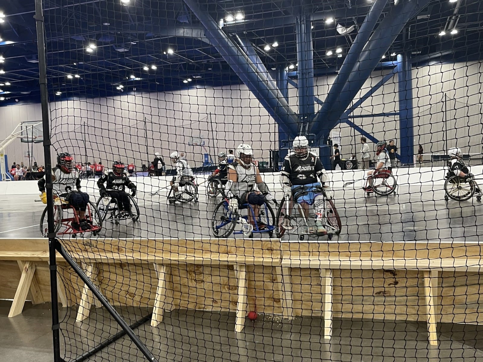 A group of people in wheelchairs in a gym

Description automatically generated