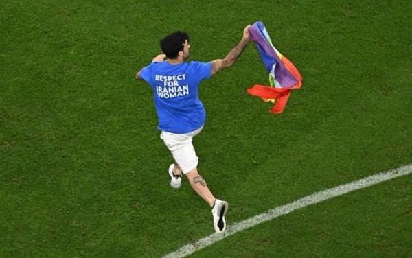 Qatar World Cup protester runs onto pitch waving rainbow flag