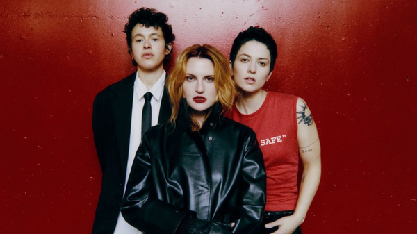 Katie Gavin, Naomi McPherson and Josette Maskin stood next to each other in front of a red wall