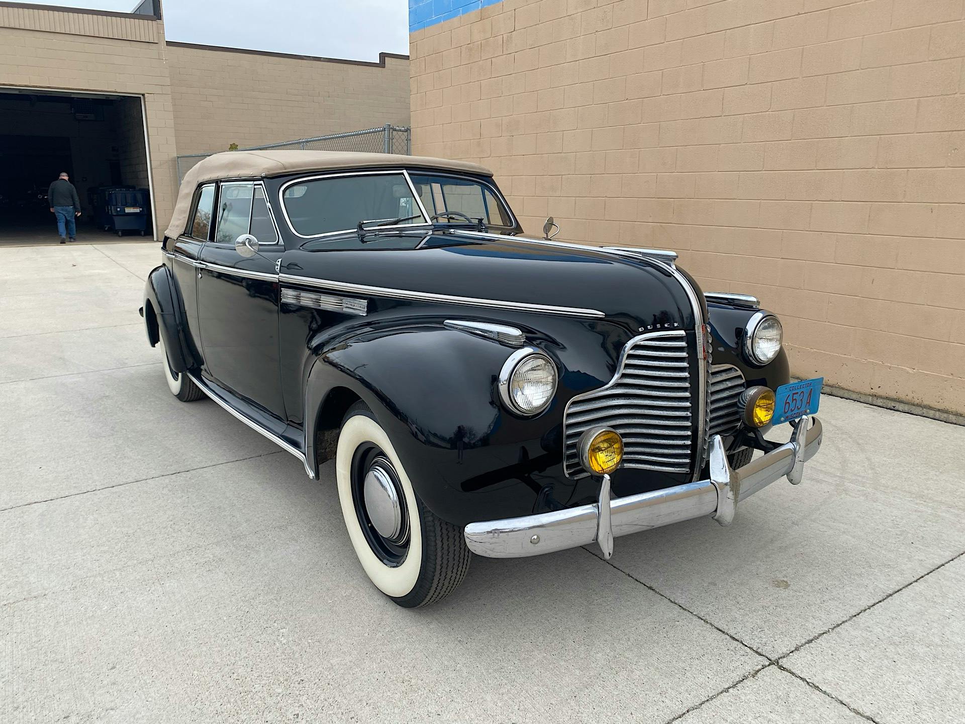 Black 1940 Buick Roadmaster Sport Phaeton with tan convertible top and whitewall tires