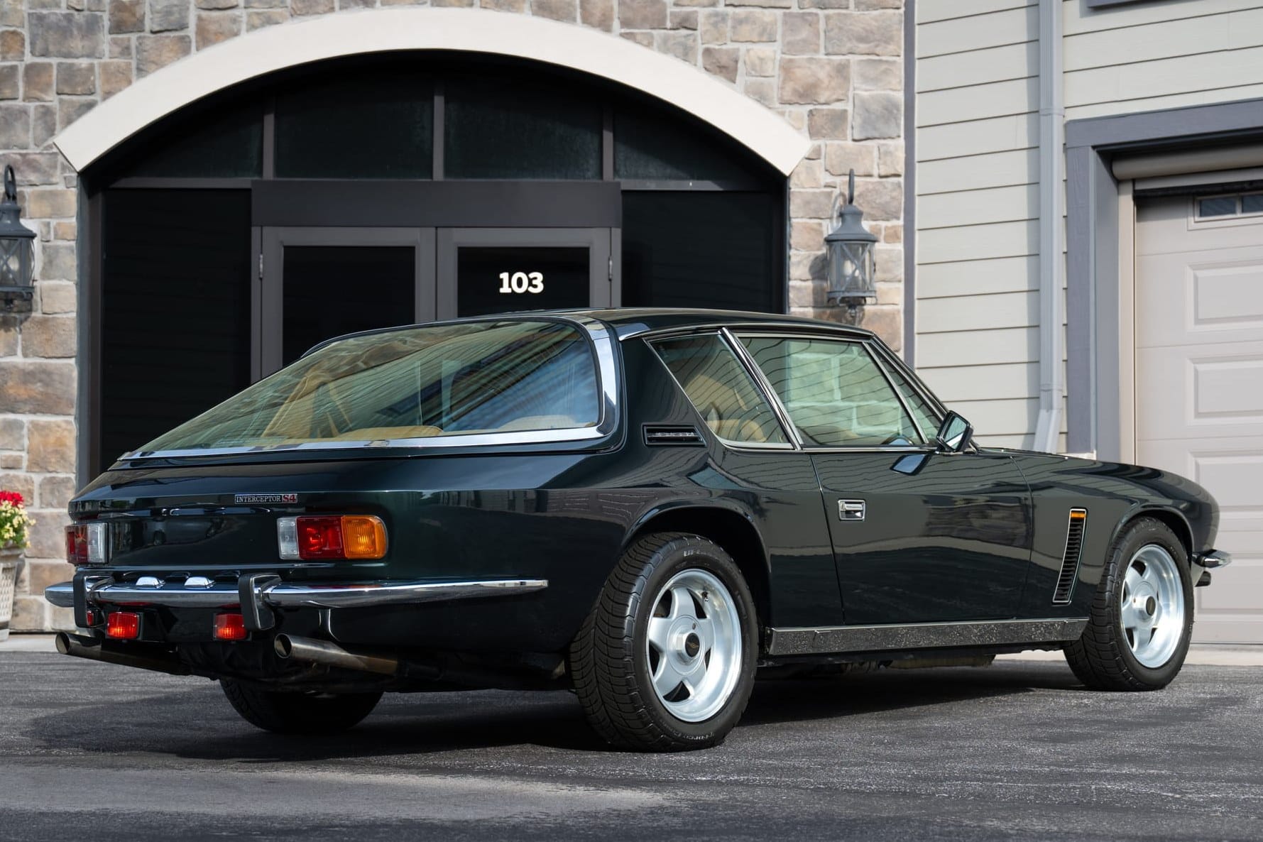 The rear three-quarter view shows the wraparound glass hatch that defines the Interceptor