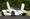 2021 McLaren Elva finished in white with a gold racing stripe, doors open, offered by Broad Arrow Auctions