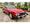 Red 1989 Mercedes-Benz 560SL parked in a driveway, listed for sale on Hagerty Marketplace