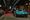 A teal classic car crossing the stage at a collector car auction
