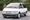 White and gray 1995 Toyota Previa LE S/C minivan parked in front of trees