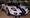 White 2005 Ford GT with blue racing stripes on display, one of the top sellers at Mecum Nashville