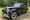 Black 1950 Rolls-Royce Silver Dawn sedan parked on gravel in front of a tree line