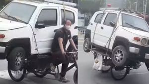Man On Tricycle Hauls An SUV