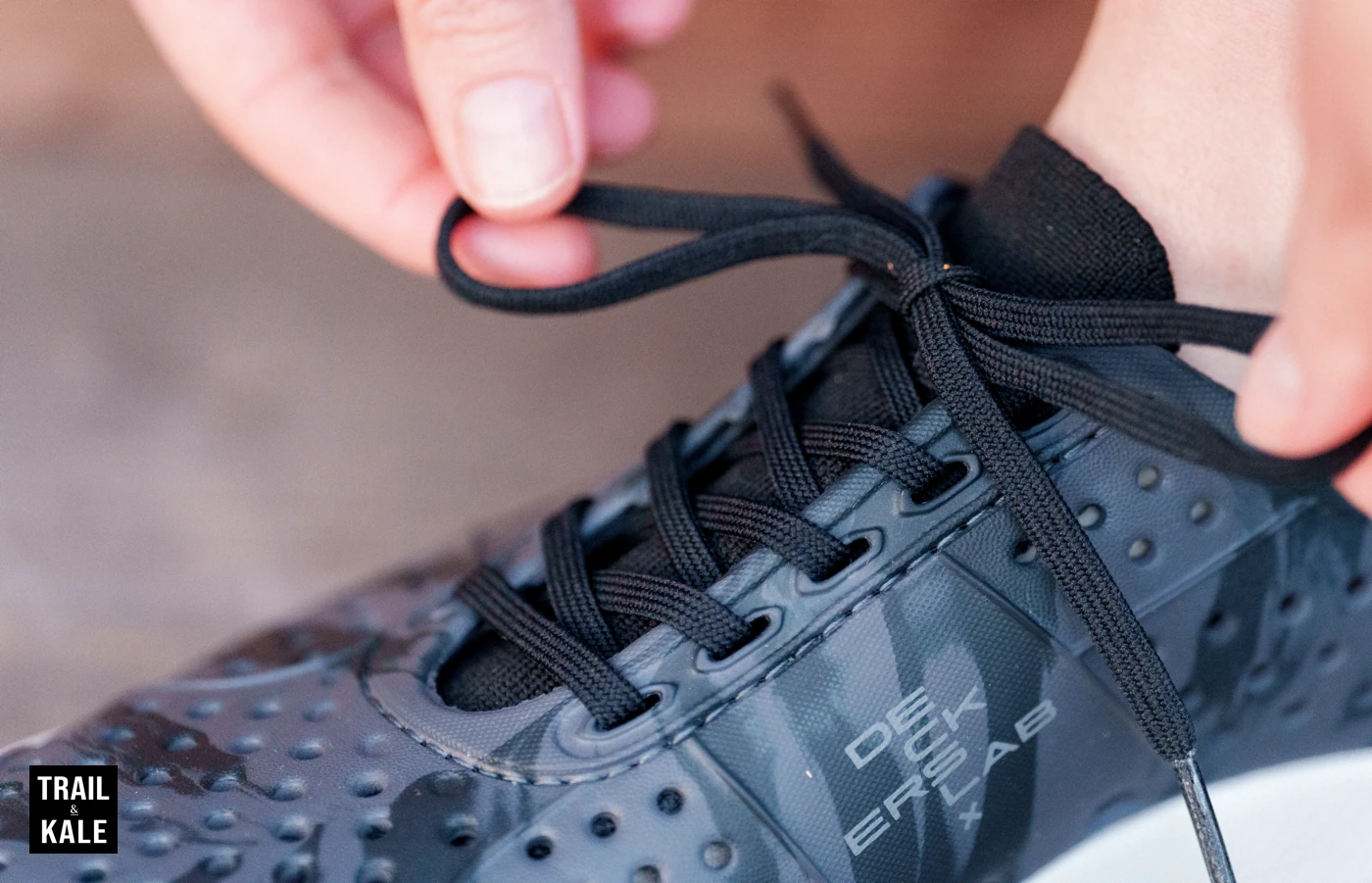 The tongue, laces and holey upper of the Deckers X Lab X SCAPE BAJA water, land and recovery shoes.