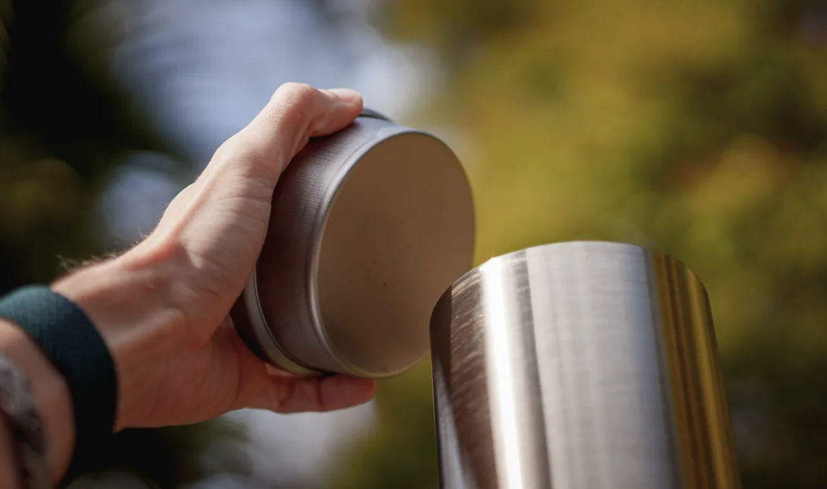 Removing the lid from the chimney before firing it up.