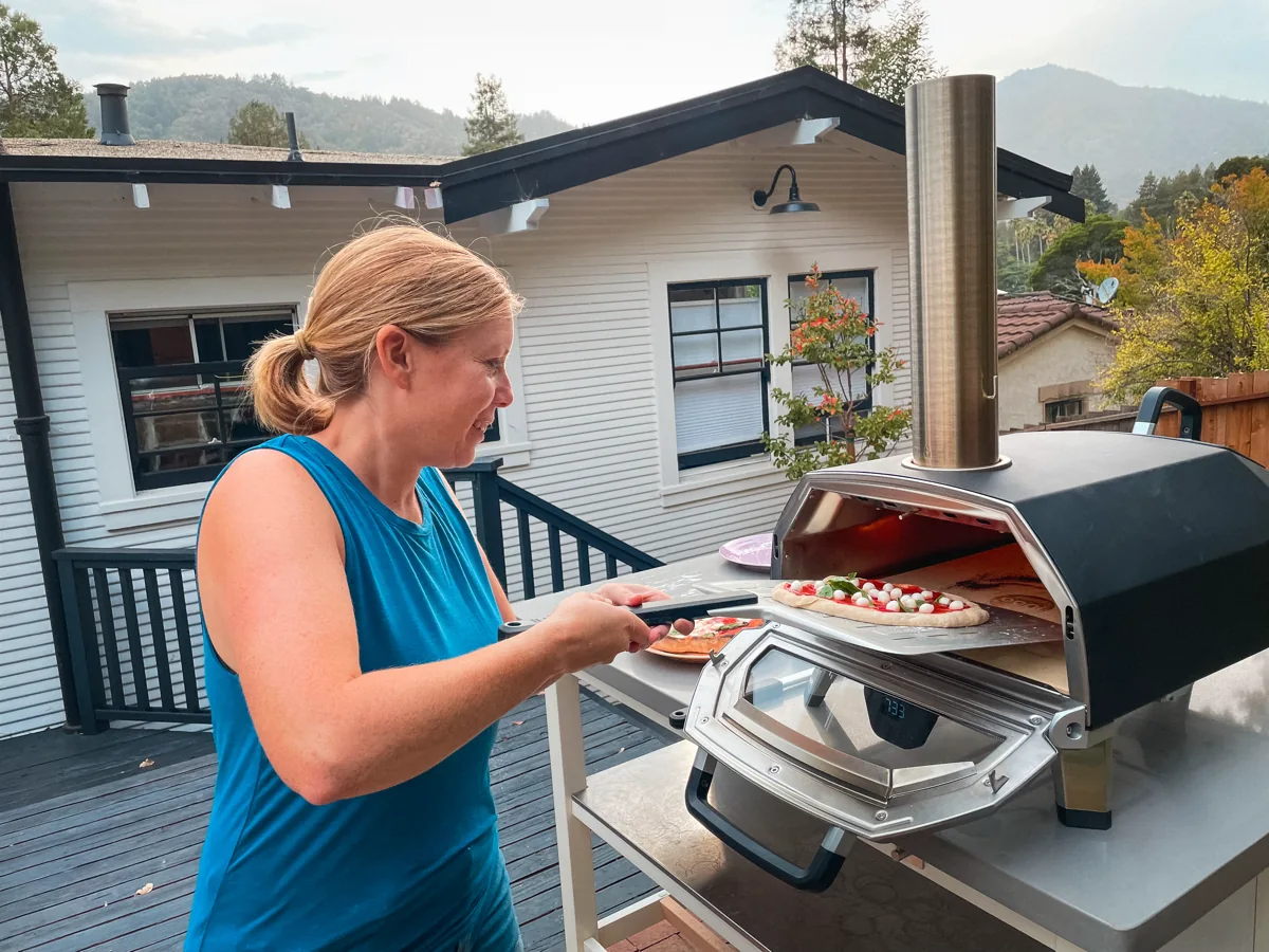 Helen launching a home-made pizza into the Ooni gas pizza oven
