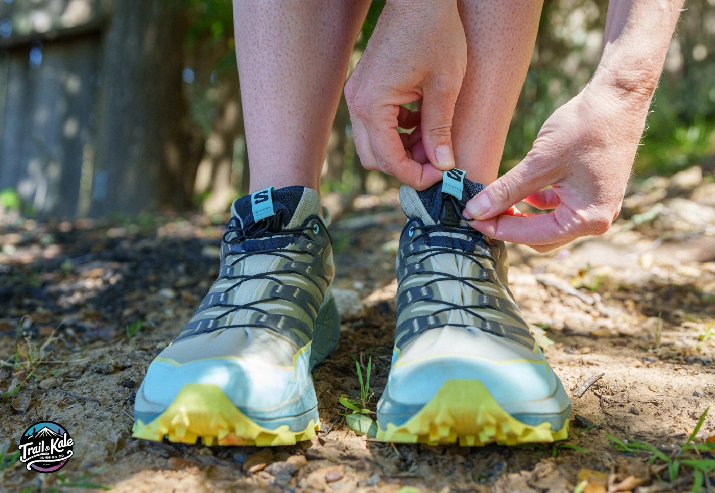 Tucking the laces away in the built-in lace garage on the tongue of the Salomon Thundercross trail shoes.