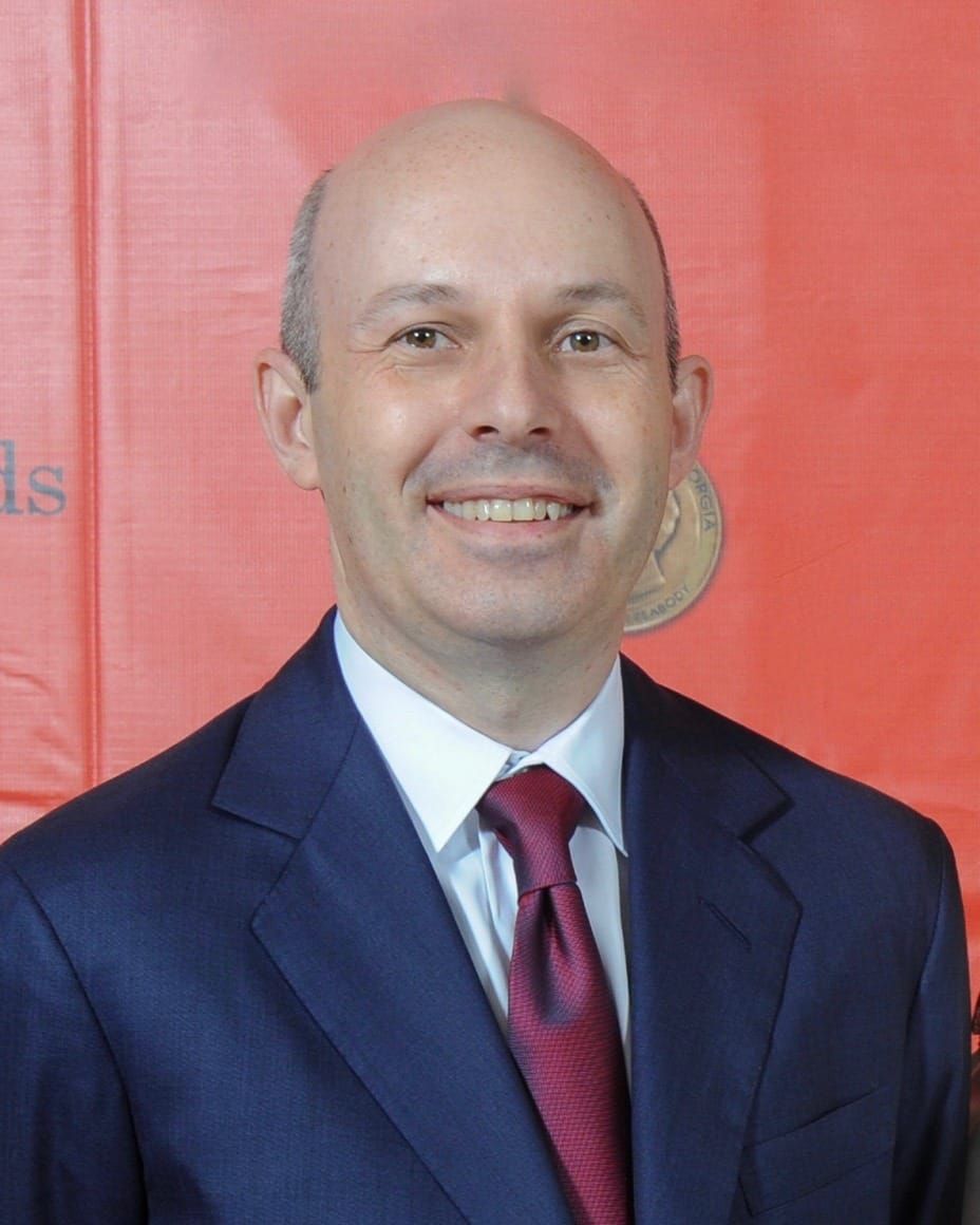Tom Goldstein in a dark suit and red tie at the 2013 Peabody Awards.