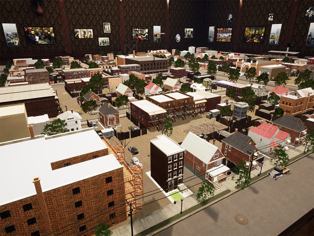 A screenshot from Philip Mallory Jones' Time Machine: Bronzeville featuring a 3d model of Chicago's South Side neighborhood from a 3/4 aerial perspective. The model appears to be in a room whose brown wallpapered walls feature historical photographs. 