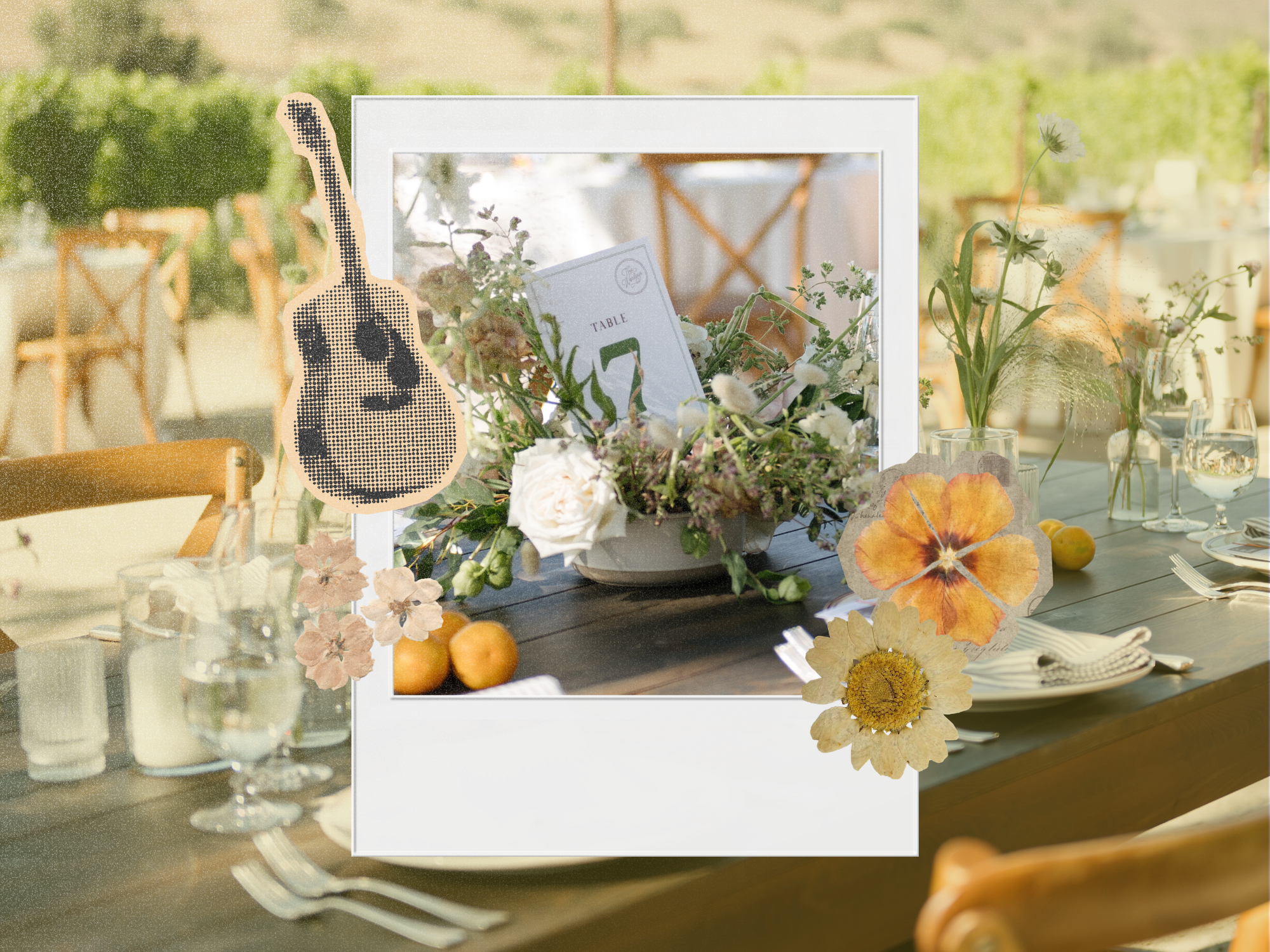 Wedding table number card in a wildflower centerpiece, shown as a polaroid over an outdoor vineyard reception table with pressed flowers and a halftone guitar