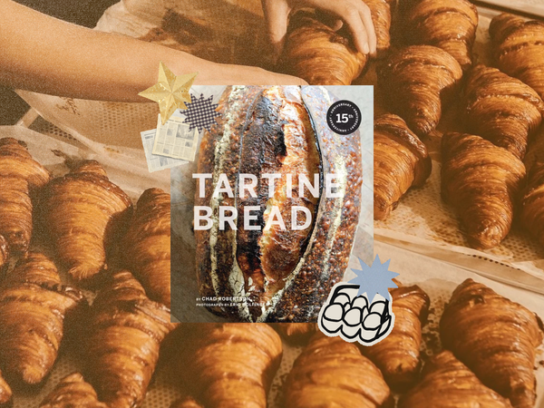 Tartine Bread by Chad Robertson cookbook cover collaged over a tray of croissants with gold star and blue starburst stickers