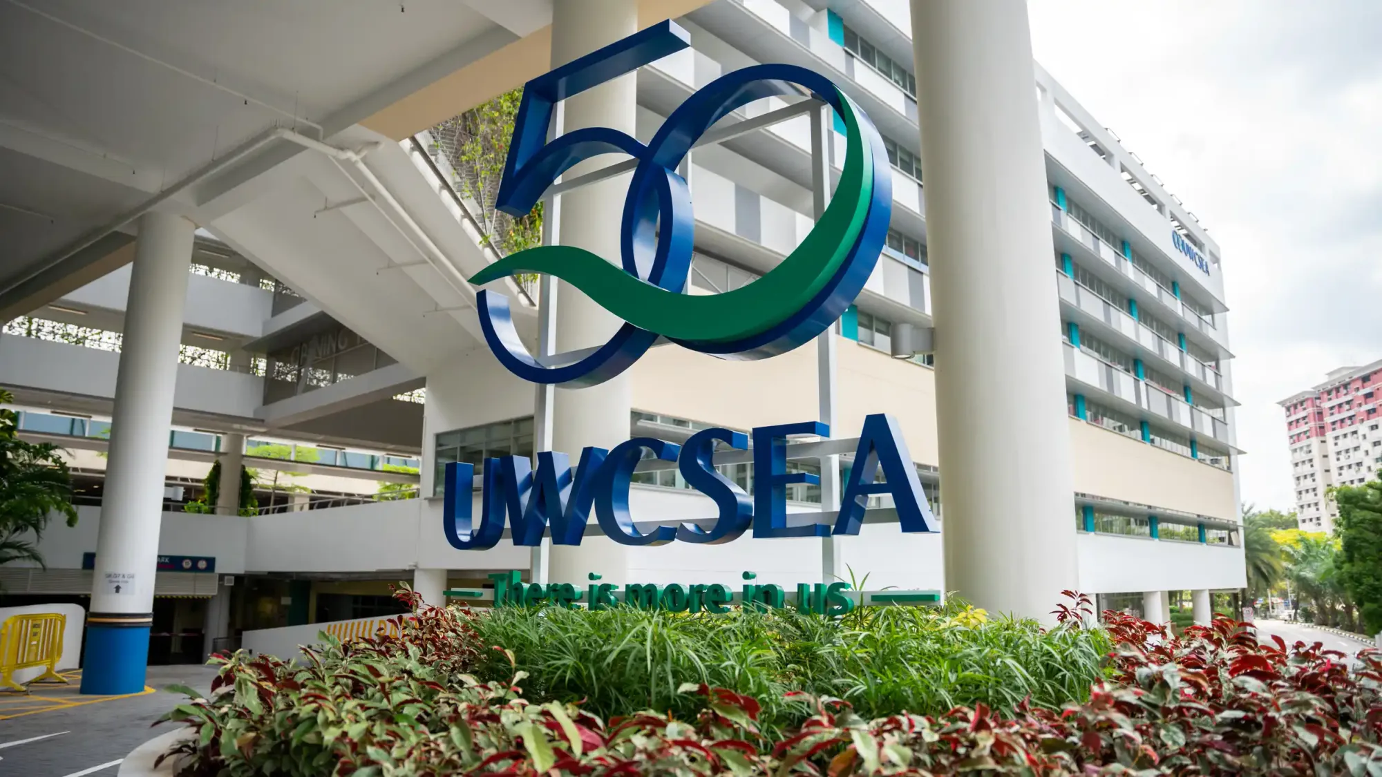 Large “50” sign and UWCSEA logo displayed prominently at the school’s campus entrance.