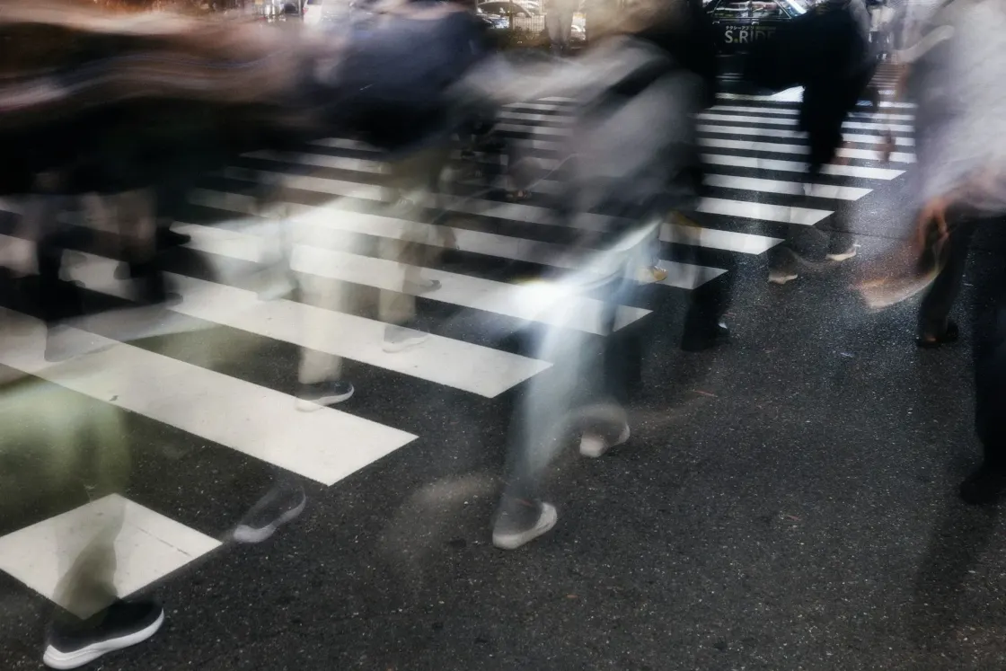 Long exposure of commuters on a zebra crossing, symbolising global talent flow across APAC, Europe and the USA in 2025 employer branding.