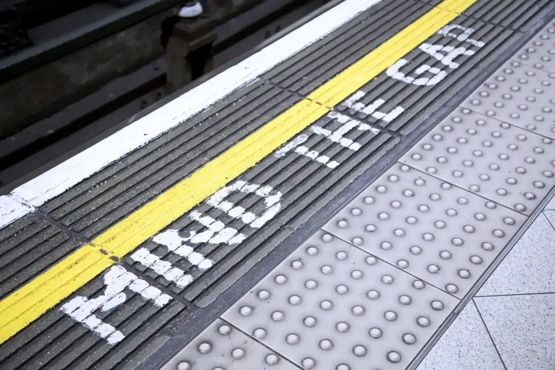 Mind the gap warning on London Underground platform, illustrating the 2026 AI integration gap between leaders and employees.