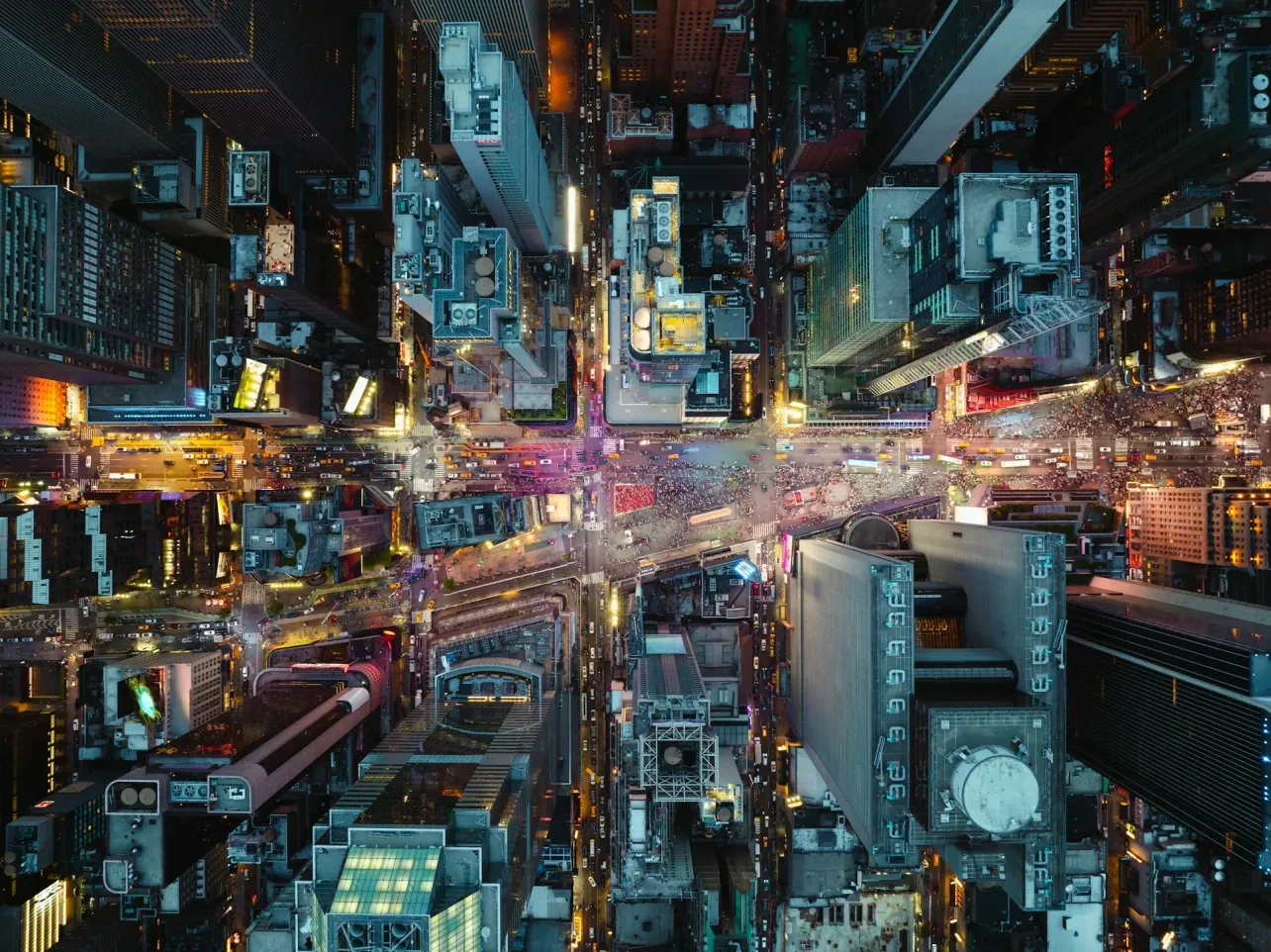 Aerial view of a bustling city intersection, symbolising the complex, interconnected forces shaping the future of work and leadership.